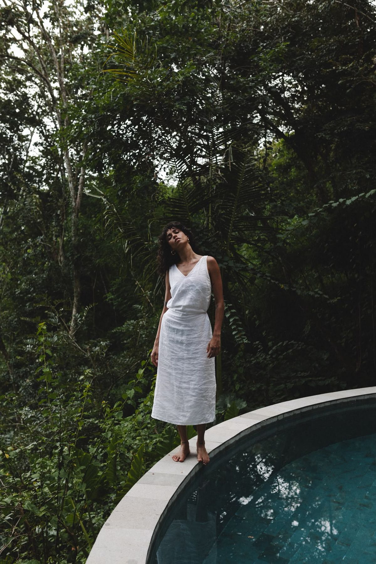 Woman standing by a private jungle pool villa in Lombok